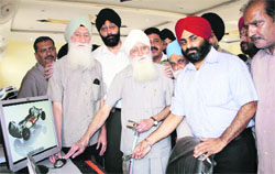 Mahinder Singh Bhogal, founder president United Cycle & Parts Manufacturer, inaugurates a computer centre in Ludhiana on Monday.