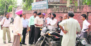 Agitated parents outside Government Model Senior Secondary School, Dholewal, in Ludhiana on Monday. 