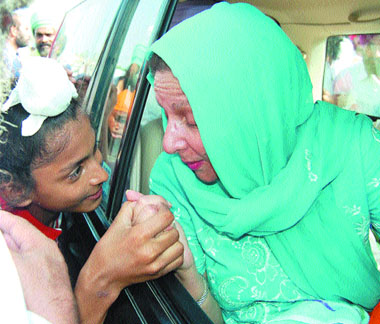 MP Perneet Kaur, wife of former CM Amarinder Singh, talks to a child during her visit to Amritsar on Tuesday.