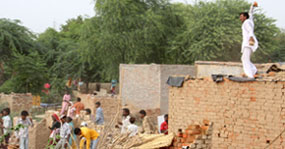 Residents pelting stones at the police and PUDA official at Dhobiana Basti area in Bathinda on Tuesday.