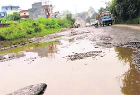 A view of the potholed Pinjore-Baddi road at Pinjore