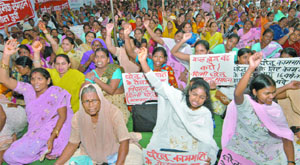 Activists of the Delhi Sharamik Sangathan demand regulation of employment and social security for domestic and unorganised sector workers at Jantar Mantar in New Delhi on Tuesday.