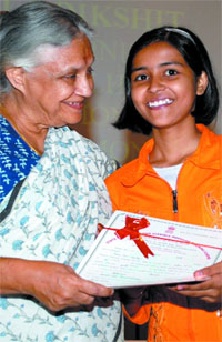 Chief Minister Sheila Dikshit presents certificate to the topper of the first batch of the Technical Education Community Outreach Scheme at a function in New Delhi on Tuesday.