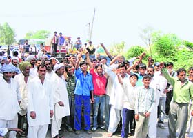 Residents of Makroli village in Rohtak district block a road on Tuesday in protest against power shortage in the village