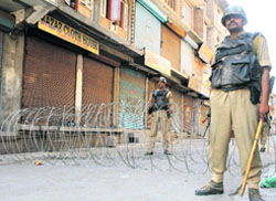 CRPF jawans stand guard in the curfew-bound Lal Chowk area of Srinagar