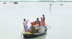 Villagers use a country boat to wade through floodwaters in Araria, around 350 km northeast of Patna