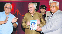 Haryana Governor Dr A.R. Kidwai (right) releases the book i witness by union minister Kapil Sibal, at a function organised at Raj Bhawan in Chandigarh on Tuesday. H.K. Dua, Editor-in-Chief, The Tribune, cheers the author