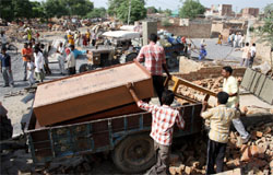 Residents of Dhobiana Basti shift their household articles after PUDA razed their illegal dwellings under its demolition drive in Bathinda