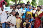 Dwellers of Dhobiana Basti show their voter cards and ration cards, issued under the state government's Atta-Dal scheme, lamenting that they were of no use to them anymore. They said they were cheated by the ruling party.