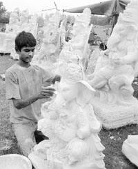 An artist makes idols of Lord Ganesha for the coming Ganesh Chaturthi in Ambala. 