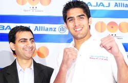 Olympic medal winner Vijender Kumar (right) poses with Akshay Mehrotra, head, marketing, Bajaj Allianz Life Insurance, in New Delhi on Thursday