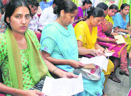 Women look at appointment letters handed over to them by Education Minister Dr Upinderjit Kaur in Mohali on Thursday.