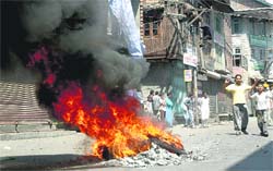 Kashmiri protesters burn tyres at the Budshah chowk during the curfew relaxation in Srinagar on Thursday.