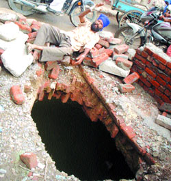 A patch of road which caved in on the old Sultanwind bridge in Amritsar.