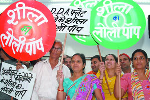 BJP workers hold banners during a 'Lollypop' demonstration against Delhi Chief Minister Sheila Dikshit in New Delhi on Friday.
