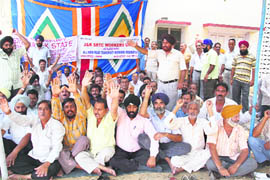 Members of the J&K State Transport Workers Union protest in support of their demands in Jammu on Friday.