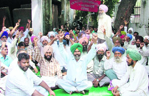 Class IV government employees stage a dharna in front of the civil surgeons office in Ludhiana 