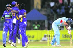 Sri Lanka's Ajantha Mendis  celebrates with teammates Kumar Sangakkara  and Chamara Kapugedera the dismissal of India's Yuvraj Singh  during the fifth and final one-day international match in Colombo