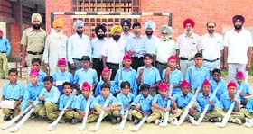 Fatehgarh Sahib SSP Kaustubh Sharma with students after presenting them hockey sticks and kits
