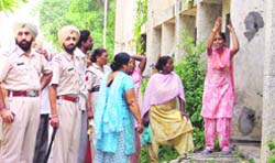 A woman protests after being evicted from a flat in Ludhiana