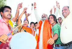 Members of the local unit of the VHP celebrate the resolution of the Amarnath land crisis, at Laxmi Narayan Temple in Sector 20, Chandigarh, on Sunday.