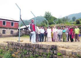 Residents of Chandmari village stand near the pillars erected by the Army authorities in the playground of the local school