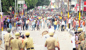 People and policemen clash during celebrations over the land row pact in Jammu on Sunday.