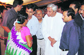 Orissa Chief Minister Navin Patnaik interacts with a victim at a riot camp in Kandhamal on Sunday. 