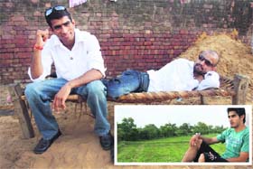 Indian boxers Akhil and Jitender (L), who reached quarterfinals at the Beijing Olympic pose at latter's house in Devsar village of Bhiwani on Saturday evening. Vijender Kumar (inset) at the roof of his house at Kaulwas village of Bhiwani