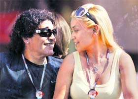 Argentinian soccer great Diego Maradona (L) and his girlfriend Veronica Ojeda attend the MotoGP race during the San Marino Grand Prix at Misano racetrack