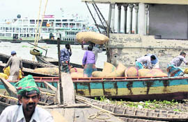 Bangladeshi labourers unload sacks of potatoes on the outskirts of Dhaka on Sunday. Spiralling food prices have pushed an estimated four million Bangladeshis below the poverty line despite the countrys strong economic growth, the World Bank said.