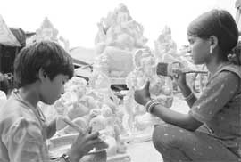 Girls give final touches to idols of Lord Ganesha ahead of Ganesha Chaturthi in Ambala.