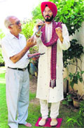 An artist gives finishing touches to a wax statue of Ishmeet Singh a day before his birthday