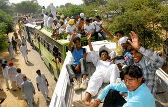 SAD supporters sitting on the roofs of buses on their way back home after attending the foundation stone laying ceremony of the 1980 MW at village Banwala (Mansa) on Tuesday