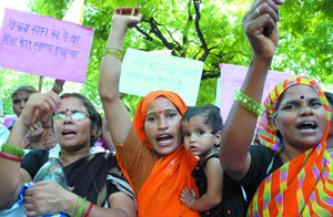 Anganwadi workers participate in a demonstration for 'Rights of Children' at Jantar Mantar in New Delhi on Tuesday. 