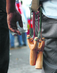 An anti-government demonstrator is seen with sling shots in his back pocket after clashes with government supporters in Bangkok on Tuesday.