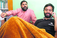 JKLF chief Yaseen Malik (right) under house arrest in Srinagar on Wednesday.
