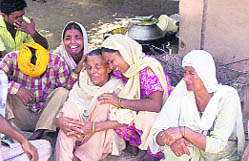 Relatives of Pritam Singh, who was allegedly beaten to death by policemen, wail outside his house at Shah Abu Bakkar village in Moga district