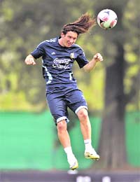Argentina's Lionel Messi heads the ball during a training session of his national soccer team in Buenos Aires