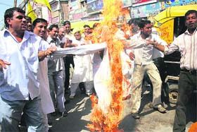 Activists of the Haryana Janhit Congress burn an effigy of Chief Minister Bhupinder Singh Hooda over alleged irregularities in the BPL survey in Rohtak