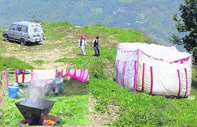 Two persons inspect the chunk of land purchased by Priyanka Vadra at Charabra, 12 km from Shimla, on Thursday; and (inset) the place where bhoomi pujan was performed.
