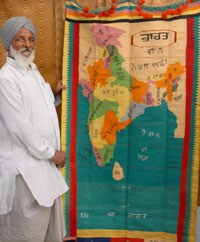 Karnail Singh showing the carpet that he made pain-stakingly way back in 1971. 