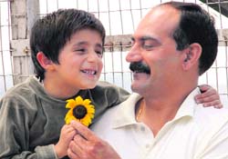 A student offers a flower to his teacher on Teachers Day in Shimla