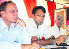 S.R. Kler, additional chief administrator of PUDA, along with additional deputy commissioner Priyank Bharti, conducts the auction at PUDA House in Ludhiana on Friday. 