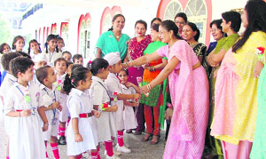 Students of a school in the city greet their teachers with flowers.