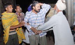 Villagers thrashing a policeman at village Joga Nand in Bathinda in the wee hours