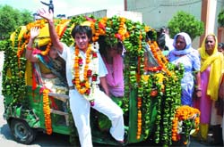 FIRST WOMAN AUTO DRIVER: Delhis first woman auto driver Sunita Chaudhury waves to the media during an auto driving training programme for women in New Delhi on Sunday. 