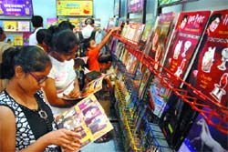 Children glance over a book on Harry Potter on the last day of Delhi Book Fair  2008 at Pragati Maidan in New Delhi on Sunday. 