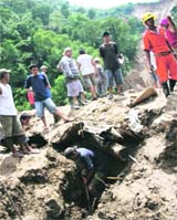 Rescuers search for survivors after a mudslide hit Massara vllage, Compostela Valley province, in southern Phillippines on Sunday. Rescue workers pulled eight bodies buried under mud after days of monsoon rains loosened soil and burried about 20 makeshift houses near a mining town. 