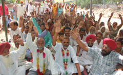 Residents of Dhobiana Basti who were uprooted after their homes were demolished by PUDA recently staging protest in Bathinda on Monday.